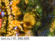 Golden ball is hanging on a spruce branch. Стоковое фото, фотограф Галина Царькова / Фотобанк Лори