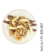 Belgian waffle with nuts, banana and chocolate. Isolate on a white background. Стоковое фото, фотограф Bogdanova Mariia / Фотобанк Лори