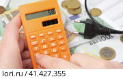 Person Counting and Calculate Cost Money of Electricity and Heating Bill. Electric Cap, Light Bulb and Euro Banknotes on the Background. Increase in the Cost of Electricity. Price Hike. Energy Crisis. Стоковое видео, видеограф Марина Демидюк / Фотобанк Лори
