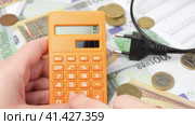 Person Counting and Calculate Cost Money of Electricity and Heating Bill. Electric Cap, Light Bulb and Euro Banknotes on the Background. Increase in the Cost of Electricity. Price Hike. Energy Crisis. Стоковое видео, видеограф Марина Демидюк / Фотобанк Лори