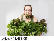 Young woman with a set of green Ingredients lettuce, spinach for a healthy diet. Стоковое фото, фотограф Ольга Коваленко / Фотобанк Лори