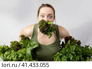 Young woman with a set of green Ingredients lettuce, spinach for a healthy diet. Стоковое фото, фотограф Ольга Коваленко / Фотобанк Лори