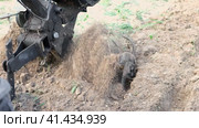 Powerful cultivator, Tiller. Gardening. Spring work on the farm. Land cultivation with a Motor ripper. Man plows the ground. Spring soil preparation for seeding. Husbandman, grower. Moto plow working. Стоковое видео, видеограф Марина Демидюк / Фотобанк Лори