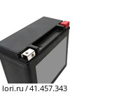 Photo of rechargeable starter lead-acid battery for motorcycle, jet ski or snowmobile. Positive terminal is shut with red cap. Isolated on white background. Space for logo. Фотография перезаряжаемой стартерной свинцово-кислотной батареи для мотоцикла, гидроцикла или снегохода. Положительная клемма закрыта красным колпачком. Изолированный на белом фоне. Место для логотипа. Стоковое фото, фотограф Дмитрий Березнев / Фотобанк Лори