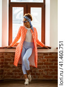 African model woman in orange spring jacket and blue pants. Стоковое фото, фотограф Андрей Аркуша / Фотобанк Лори