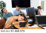 Exhausted young female student sleeping at table in computer classroom. Стоковое фото, фотограф Яков Филимонов / Фотобанк Лори