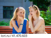 Two young beautiful women secret at summer green park. Стоковое фото, фотограф Андрей Аркуша / Фотобанк Лори