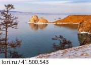 Baikal Lake in December. View of natural landmark of Olkhon Island - the Shamanka Rock and freezing bay in sunset light. Natural background. Beautiful landscape. Travel and outdoor recreation. Стоковое фото, фотограф Виктория Катьянова / Фотобанк Лори