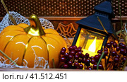 Decorative lantern with candle next to pumpkin. Autumn interior decoration. Стоковое видео, видеограф Елена Смыкова / Фотобанк Лори