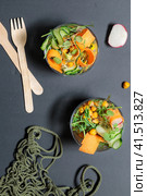 Two bowls with fresh vegetables, chickpeas and microgreens, on a black background, top view. Стоковое фото, фотограф Bogdanova Mariia / Фотобанк Лори
