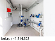 Modern independent heating system in boiler room. Pipelines, water pump, valves, manometers. Стоковое фото, фотограф Дмитрий Головач / Фотобанк Лори