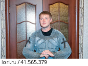 A man dressed up in a knight's hauberk at home in his room. Knight's sword in the hands of a man. Стоковое фото, фотограф Леонид Еремейчук / Фотобанк Лори