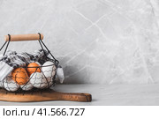 Fresh farm eggs in a stylish vintage iron basket on a gray background. The concept of natural, healthy nutrition. Useful products. Стоковое фото, фотограф Photojuli / Фотобанк Лори