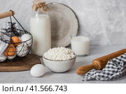 Fresh dairy products, milk, cottage cheese, eggs in stylish ceramic dishes on a gray background. The concept of natural, dietary nutrition. Useful products. Стоковое фото, фотограф Photojuli / Фотобанк Лори