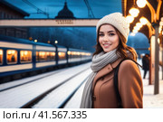 cheerful beautiful woman on railway station perron at winter early evening. Travelling and vacations concept.. AI. Стоковое AI-изображение, AI-художник Sergey Grishin / Фотобанк Лори