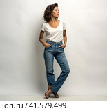 A young smiling confident pretty attractive European girl of 20 years old in a gray casual T-shirt, looking away, isolated on a white background Created by AI. Стоковое AI-изображение, AI-художник Ярославский Максим / Фотобанк Лори