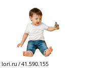 Toddler baby plays with a musical rattle bells on a stick, studio isolated on a white background. Happy child musician playing percussion musical instrumen. Kid aged one year and four months. Стоковое фото, фотограф Андрей Журавлев / Фотобанк Лори