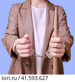 Arrested woman teacher handcuffed on a blue background, copy space. Стоковое фото, фотограф Андрей Журавлев / Фотобанк Лори