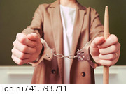 Restrained woman teacher handcuffed on a school blackboard in the classroom, copy space. Стоковое фото, фотограф Андрей Журавлев / Фотобанк Лори