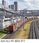 Freight transport against the background of modern buildings and road overpasses - Moscow, Russia, October 15, 2020. Редакционное фото, фотограф Андрей Журавлев / Фотобанк Лори