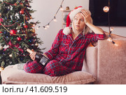Sad lonely middle aged woman complaining in christmas sitting on couch. Стоковое фото, фотограф Гладских Татьяна / Фотобанк Лори