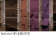 Film strip background with old scratches against cinema hall loopable. Стоковое видео, видеограф Олег Грач / Фотобанк Лори
