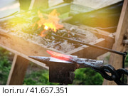 Hot knife blade on the anvil. Workpiece in the forge on the background of the fire. The heat from the stove and the blade of the forged sword. Стоковое фото, фотограф Андрей Журавлев / Фотобанк Лори
