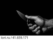 A sharp knife in the man's hand. The use of cold weapons. Knife attack . Armed raid. Стоковое фото, фотограф Алексей Круковский / Фотобанк Лори