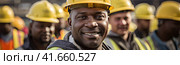 A confident and smiling staff of factory workers, engineers, managers and foremen stands on the territory of the heavy industry production plant. Generated by AI. Стоковое AI-изображение, AI-художник Ярославский Максим / Фотобанк Лори