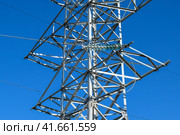 Supports high-voltage power lines against the blue sky. Стоковое фото, фотограф Леонид Еремейчук / Фотобанк Лори
