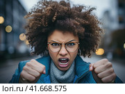 A woman in a state of extreme rage, with clenched fists and jaw, angry, emotional and furious, is singled out for office. Generated by AI. Стоковое AI-изображение, AI-художник Ярославский Максим / Фотобанк Лори