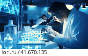Microbiologist scientist looking through a microscope. Стоковое AI-изображение, AI-художник Кирилл Черезов / Фотобанк Лори