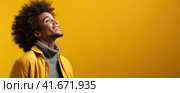 A banner for a website or poster with a free yellow background with a young African American smiling and looking up. Copyspase. Generated by AI. Стоковое AI-изображение, AI-художник Ярославский Максим / Фотобанк Лори