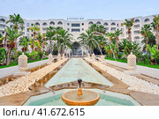 View of the hotel, Kantaoui Bay Iberostar Selection. Fountain in front of the hotel and the inscription Kantaoui Bay - Mideast, Tunisia, Sousse, Africa 06 14 2019. Редакционное фото, фотограф Андрей Журавлев / Фотобанк Лори