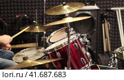 A musician drummer plays a drum kit in a recording studio. Drumming in the rehearsal base. Стоковое видео, видеограф Андрей Журавлев / Фотобанк Лори