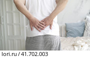 Back pain, kidney inflammation, man suffering from backache at home, health problems concept. Стоковое видео, видеограф Станислав Тарко / Фотобанк Лори