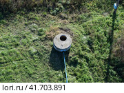 Well of an artesian well with a submersible pump. Covered with a concrete well. Стоковое фото, фотограф Леонид Еремейчук / Фотобанк Лори