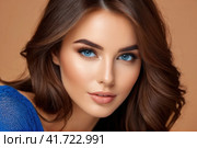 Close-up portrait of beautiful sensual caucasian woman with brown hair wearing blue clothes on a blue background.. AI. Стоковое AI-изображение, AI-художник Sergey Grishin / Фотобанк Лори