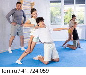 Boy and girl train to perform defense of strangling opponent, while learning self-defense. Стоковое фото, фотограф Яков Филимонов / Фотобанк Лори