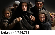 Portrait of Refugees on middle east looking at camera. Homeless people, unhappy and frightened, shawl camps,  Generative AI. Стоковое AI-изображение, AI-художник Анна Кривицкая / Фотобанк Лори