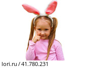 A funny laughing child in the guise of a rabbit on white bacground. The year according to the zodiac sign of the Eastern calendar. Easter Greeting poster. Стоковое фото, фотограф Ирина Старикова / Фотобанк Лори