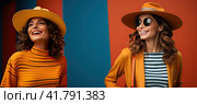Two beautiful brunette with curly hair in sunglasses posing in front of the camera in a yellow studio. Стоковое AI-изображение, AI-художник Ярославский Максим / Фотобанк Лори