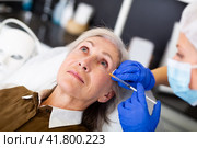 Cosmetologist doing botulotoxin injections for senior woman. Стоковое фото, фотограф Яков Филимонов / Фотобанк Лори