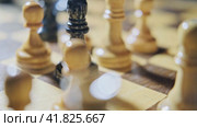 Capturing a knight by a bishop in a chess game. Man hand with a chess piece in a board game. Стоковое видео, видеограф Андрей Журавлев / Фотобанк Лори