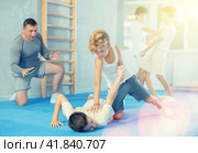 Teenager applying armlock technique to face-down opponent at self-defense classes. Стоковое фото, фотограф Яков Филимонов / Фотобанк Лори