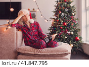 Sad lonely middle aged woman complaining in christmas sitting on couch. Стоковое фото, фотограф Гладских Татьяна / Фотобанк Лори