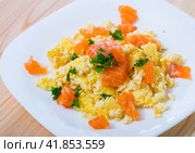 Plate with tasty scrambled omlette with salmon at plate on table. Стоковое фото, фотограф Яков Филимонов / Фотобанк Лори