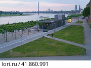 Dusseldorf, Germany - June 3, 2019: Dusseldorf embankment in Altstadt at cloudy blue sunset. Schlossturm (maritime museum) / castle tower on  Burgplatz, St. Lambert church, Oberkasseler Brücke. Редакционное фото, фотограф YuryKara / Фотобанк Лори