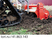 Crawler tractor plunged the cutter into the ground for loosening and mulching. Стоковое фото, фотограф Коханова Наталья / Фотобанк Лори