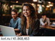 A young beautiful girl with long hair is sitting in a spacious office at a laptop and smiling. Generated by AI. Стоковое AI-изображение, AI-художник Ярославский Максим / Фотобанк Лори